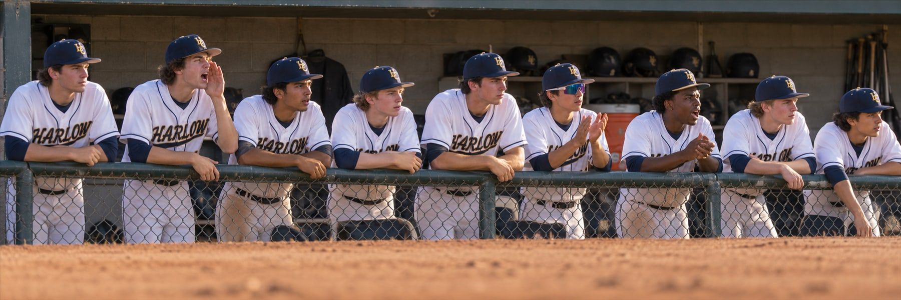 Example team photo: Harlow Creek players leaning on the dugout rail during a game